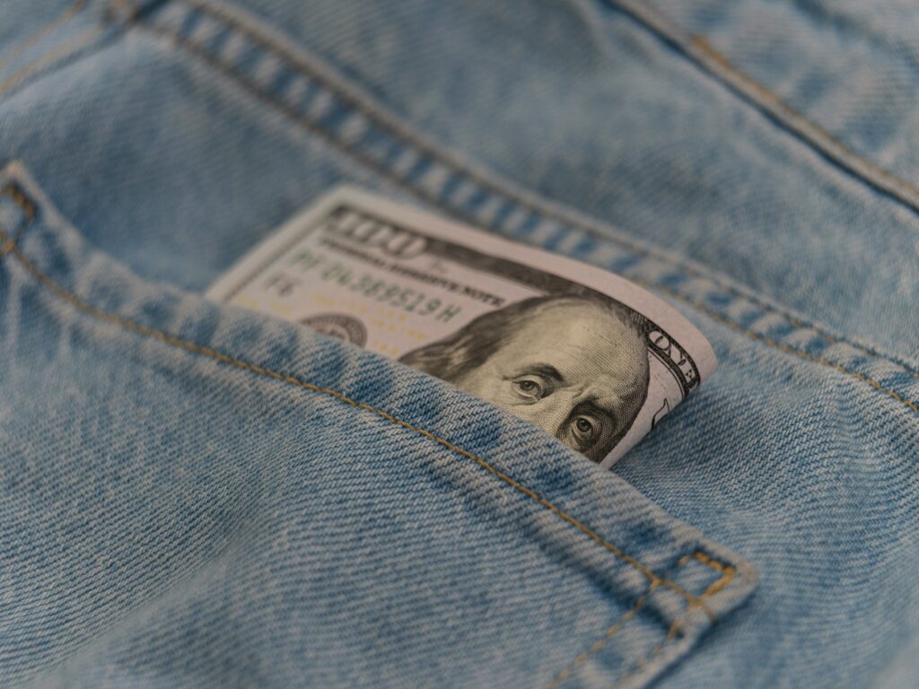 A $100 bill in a denim pocket